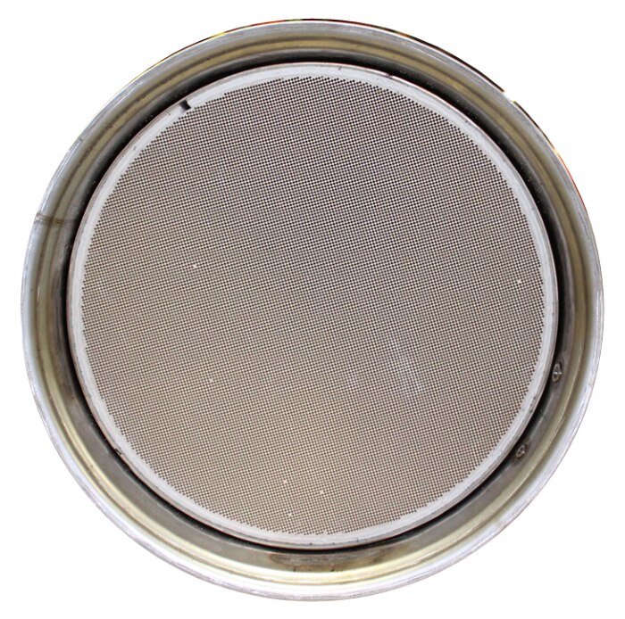 A photograph of a cordierite DPF, which is light grey and made from a single element